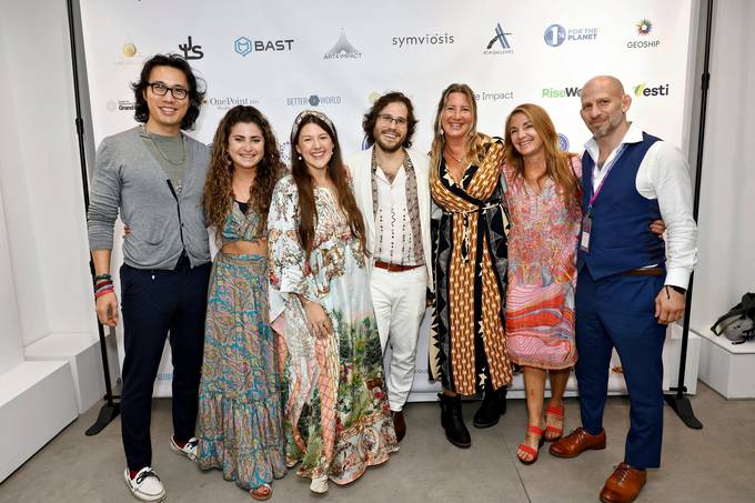 A group of seven guests including Kayla Rose Bergen and Vaughn Bergen standing in front of a sponsor wall carrying the ACA Galleries and Art For Impact logos alongside other 2025 summit sponsors.