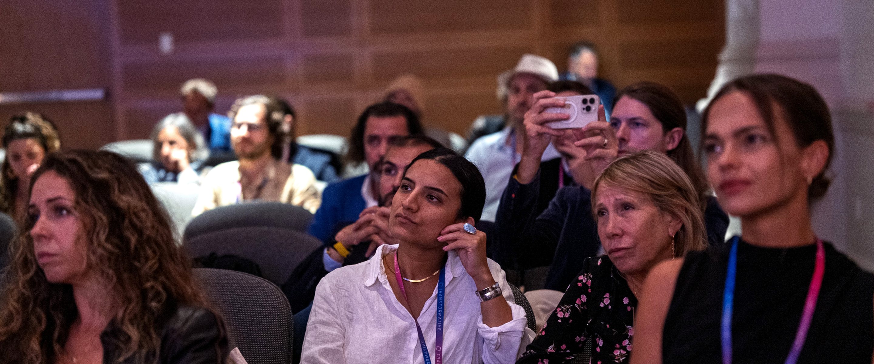 The audience at the Transformative Impact Summit, seated in the Sheen Center theatre, listening to a session.
