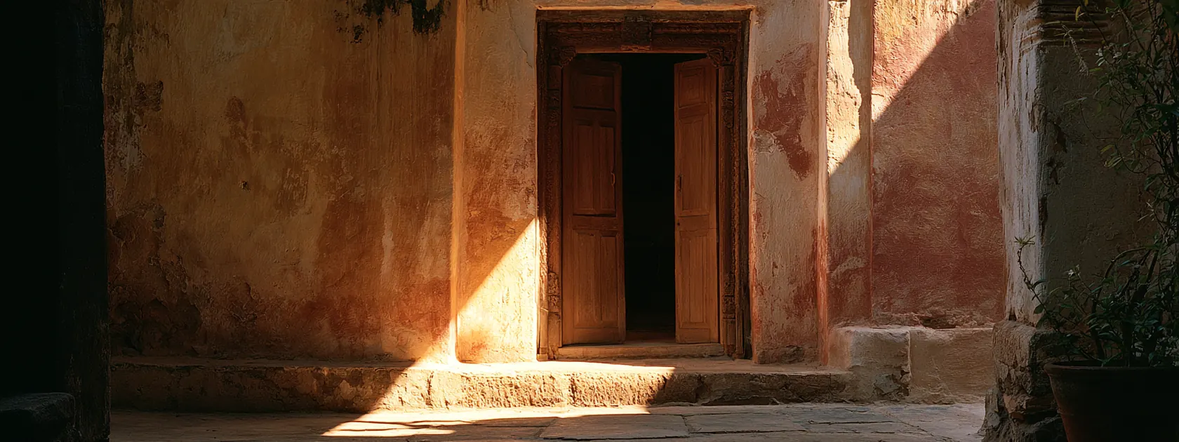 A courtyard doorway in southern India in early morning light